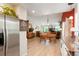 Open concept kitchen, dining and living room with stainless steel appliances, hardwood floors and vaulted ceilings at 7344 S Sheephorn Mtn, Littleton, CO 80127