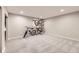 Spacious, carpeted basement area with bikes mounted on the wall, offering versatile space for activities at 7830 W 90Th Ave # 67, Broomfield, CO 80021