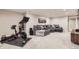 Finished basement with a home gym area and a cozy seating area with comfortable furnishings at 7830 W 90Th Ave # 67, Broomfield, CO 80021