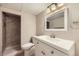 Bathroom featuring a shower with a tile accent, a vanity with a mirror, and modern fixtures at 7830 W 90Th Ave # 67, Broomfield, CO 80021