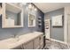 Double vanity with marble floors, dual mirrors, wall-mounted storage, and recessed lighting in full bathroom at 7830 W 90Th Ave # 67, Broomfield, CO 80021