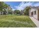 Lush front lawn with mature trees, providing a welcoming approach to the home at 7830 W 90Th Ave # 67, Broomfield, CO 80021