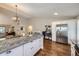 Modern kitchen with granite counters, white cabinets, and stainless steel appliances at 7830 W 90Th Ave # 67, Broomfield, CO 80021