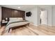 Large main bedroom featuring wood floors, an accent wall, a closet, and an ensuite bathroom at 7830 W 90Th Ave # 67, Broomfield, CO 80021