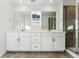 Double vanity bathroom with modern white cabinets and a large shower at 3355 N Coolidge Way, Aurora, CO 80019