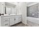 Double vanity bathroom with white cabinets and a bathtub at 3355 N Coolidge Way, Aurora, CO 80019