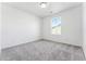 Bright bedroom featuring a window and grey carpet at 3355 N Coolidge Way, Aurora, CO 80019