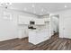 Modern kitchen with white cabinets, island, and stainless steel appliances at 3355 N Coolidge Way, Aurora, CO 80019