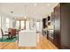 Open kitchen featuring stainless steel appliances, center island, and adjacent dining area at 4330 N Raleigh St, Denver, CO 80212