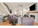 Contemporary living room with hardwood floors, a modern fireplace, and comfortable seating under a ceiling fan at 4330 N Raleigh St, Denver, CO 80212