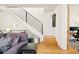 Modern staircase with black metal railings, white risers and wooden treads, next to the living room at 4330 N Raleigh St, Denver, CO 80212