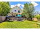 Well-maintained lawn featuring a table with umbrella and chair seating for relaxing in the backyard at 3962 Hoyt Ct, Wheat Ridge, CO 80033