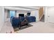 Finished basement includes an exercise bike, large sectional sofa, and stairs leading to the upper level at 3962 Hoyt Ct, Wheat Ridge, CO 80033