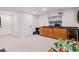 Finished basement with a bar area, storage, and carpet flooring at 3962 Hoyt Ct, Wheat Ridge, CO 80033