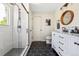 Bathroom featuring tiled shower with glass door, modern vanity with round wood mirror, and tile floor at 3962 Hoyt Ct, Wheat Ridge, CO 80033