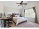 Bedroom featuring a neutral color scheme, large window, ceiling fan, and a dedicated workstation at 3962 Hoyt Ct, Wheat Ridge, CO 80033