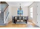 Inviting dining area with a modern table, stylish chandelier, and seamless transition to staircase at 3962 Hoyt Ct, Wheat Ridge, CO 80033
