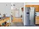 Open layout with hardwood floors connecting the entryway, kitchen, and living spaces at 3962 Hoyt Ct, Wheat Ridge, CO 80033