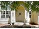 Inviting front door with wreath, framed by white pillars and a yellow archway, creating a warm entry at 3962 Hoyt Ct, Wheat Ridge, CO 80033