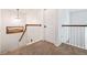 Hallway landing with carpet and white banister with wood handrail and trim at 3962 Hoyt Ct, Wheat Ridge, CO 80033