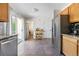 Bright kitchen with oak cabinets, granite countertops, stainless steel appliances, and slider to other rooms at 3962 Hoyt Ct, Wheat Ridge, CO 80033