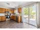 Bright kitchen with oak cabinets, granite countertops, stainless steel appliances, and slider to outdoor deck at 3962 Hoyt Ct, Wheat Ridge, CO 80033