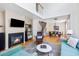 Open-concept living room with fireplace, wood floors, and seamless flow into the dining area at 3962 Hoyt Ct, Wheat Ridge, CO 80033