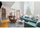Spacious living area with soaring ceilings, natural light, fireplace, and seamless flow to the dining area at 3962 Hoyt Ct, Wheat Ridge, CO 80033