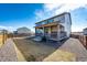 Enjoy outdoor living on the covered back patio with a grill, overlooking the gravel and lawn at 24505 E Ada Pl, Aurora, CO 80018