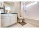 Bright bathroom features a shower over tub with tiled walls, modern vanity, and neutral tile flooring at 24505 E Ada Pl, Aurora, CO 80018