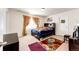 Cozy bedroom features large window with modern curtains and unique floral rug on neutral carpet at 24505 E Ada Pl, Aurora, CO 80018