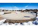 A concrete plaza offers space for gathering in this snowy community common area at 24505 E Ada Pl, Aurora, CO 80018