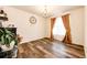 Elegant dining room featuring hardwood floors, a chandelier, and large windows at 24505 E Ada Pl, Aurora, CO 80018