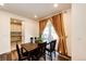 Bright dining room with a wood table and sliding glass doors leading to the outdoor deck at 24505 E Ada Pl, Aurora, CO 80018