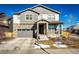 Two-story house with gray siding, stone accents, and a two-car garage at 24505 E Ada Pl, Aurora, CO 80018