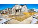 Two-story house with gray siding, stone accents, and a two-car garage at 24505 E Ada Pl, Aurora, CO 80018