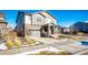 Two-story house with gray siding, stone accents, and a two-car garage at 24505 E Ada Pl, Aurora, CO 80018