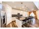 Modern kitchen featuring a large island with seating, stainless steel appliances and pendant lighting at 24505 E Ada Pl, Aurora, CO 80018