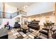 Open-concept living room with hardwood floors, abundant lighting, and staircase to the second level at 24505 E Ada Pl, Aurora, CO 80018