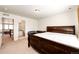 Spacious main bedroom featuring neutral carpeting and a sleek, dark-stained wood bed frame at 24505 E Ada Pl, Aurora, CO 80018