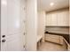 Mud room with white cabinets, drawers, and a bench on top of the tile flooring at 24505 E Ada Pl, Aurora, CO 80018