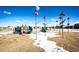 Community playground featuring slides, climbing structures, and whimsical flower-shaped decorations at 24505 E Ada Pl, Aurora, CO 80018