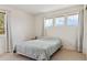 Bright bedroom featuring neutral walls, carpet flooring, and windows providing natural light at 10795 Quail Creek E Dr, Parker, CO 80138