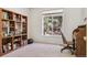 Bright home office with large window and built in shelves and desk at 10795 Quail Creek E Dr, Parker, CO 80138