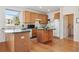 Functional kitchen with wood cabinets and a center island at 10795 Quail Creek E Dr, Parker, CO 80138