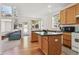 Bright kitchen with wood cabinetry and an open layout to the living area at 10795 Quail Creek E Dr, Parker, CO 80138