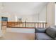 Interior view showing a spacious landing area with railing and cozy seating area at 10795 Quail Creek E Dr, Parker, CO 80138