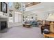 Cozy living room featuring a fireplace and large windows for natural light at 10795 Quail Creek E Dr, Parker, CO 80138