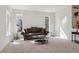 Spacious living room with neutral carpet and three large windows at 10795 Quail Creek E Dr, Parker, CO 80138