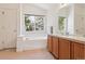 Ensuite bath with double sinks, soaking tub and lots of light at 10795 Quail Creek E Dr, Parker, CO 80138